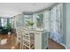 Cozy breakfast nook with an island table, hardwood floors, and large windows for natural light at 1610 Apollo Dr, Suwanee, GA 30024