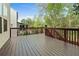 Spacious wood deck with brown railing overlooking the yard and trees at 1610 Apollo Dr, Suwanee, GA 30024