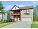 Charming two-story brick home with a covered front porch, balcony, and well-maintained landscaping at 1610 Apollo Dr, Suwanee, GA 30024