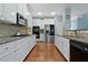 Bright kitchen featuring white cabinets, stainless steel appliances, and granite countertops at 1610 Apollo Dr, Suwanee, GA 30024