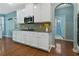 Charming kitchen with wooden floors, stainless steel appliances and an archway to the laundry room at 1610 Apollo Dr, Suwanee, GA 30024