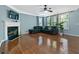 Bright living room with hardwood floors, cozy seating, and a fireplace with a decorative mantel at 1610 Apollo Dr, Suwanee, GA 30024