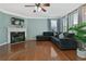 Comfortable living room featuring hardwood floors, a fireplace, and large windows with tree views at 1610 Apollo Dr, Suwanee, GA 30024