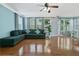 Inviting living room featuring hardwood floors, a comfortable sofa, and natural light from many windows at 1610 Apollo Dr, Suwanee, GA 30024
