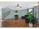Inviting living room with hardwood floors, a fireplace, and staircase at 1610 Apollo Dr, Suwanee, GA 30024