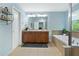 Large main bathroom featuring double sinks, a soaking tub, and a neutral color palette at 1610 Apollo Dr, Suwanee, GA 30024
