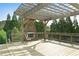 Cozy outdoor fireplace and pergola area on a wooden deck with seating at 1610 Apollo Dr, Suwanee, GA 30024