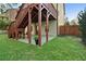 Outdoor patio area with stairs leading to a wooden deck and lush greenery at 1610 Apollo Dr, Suwanee, GA 30024