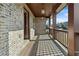 Charming porch with exposed brick and wood flooring, featuring a railing and exterior lantern style lighting at 1610 Apollo Dr, Suwanee, GA 30024
