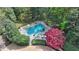 Aerial view of a backyard swimming pool surrounded by lush greenery at 4195 Woodland Brook Se Dr, Atlanta, GA 30339