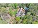 Aerial view of a beautiful home with a pool surrounded by lush greenery and mature trees at 4195 Woodland Brook Se Dr, Atlanta, GA 30339