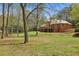 Expansive backyard featuring a brick home with a deck and lush green lawn at 4195 Woodland Brook Se Dr, Atlanta, GA 30339