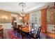 Formal dining room with a large table, chandelier, and decorative wallpaper for sophisticated dining at 4195 Woodland Brook Se Dr, Atlanta, GA 30339