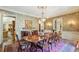 Elegant dining room with hardwood floors, decorative wallpaper, and a large table setting at 4195 Woodland Brook Se Dr, Atlanta, GA 30339