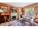 Cozy living room features a fireplace, ample seating, and access to outdoor patio at 4195 Woodland Brook Se Dr, Atlanta, GA 30339