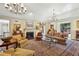 Sophisticated living room featuring a fireplace, chandeliers, and plush seating for elegant gatherings at 4195 Woodland Brook Se Dr, Atlanta, GA 30339
