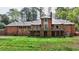 Brick home featuring multiple balconies overlooking a green backyard at 4195 Woodland Brook Se Dr, Atlanta, GA 30339