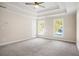 Bright bedroom with a ceiling fan, recessed lighting, and large windows at 6493 Crooked Creek Pl, Lithonia, GA 30058