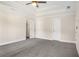 Spacious bedroom with a ceiling fan, carpeting, and ample natural light at 6493 Crooked Creek Pl, Lithonia, GA 30058