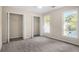 Bedroom with neutral paint, carpeting, and closets near a window at 6493 Crooked Creek Pl, Lithonia, GA 30058