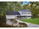 Charming two-story home with blue shutters, attached garage, and long driveway leading to a well-manicured lawn at 6493 Crooked Creek Pl, Lithonia, GA 30058
