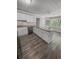 Kitchen with white cabinets, granite countertops, stainless steel appliances, and light wood floors at 6493 Crooked Creek Pl, Lithonia, GA 30058