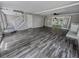 Open concept living area with grey wood flooring, recessed lighting, neutral walls, and white trim and ceiling at 6493 Crooked Creek Pl, Lithonia, GA 30058