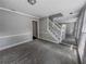 Spacious living room with carpet, a staircase, neutral paint, and plenty of natural light from the windows at 6493 Crooked Creek Pl, Lithonia, GA 30058