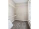 A carpeted walk-in closet with wire shelving, and natural light from the window at 6493 Crooked Creek Pl, Lithonia, GA 30058