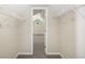 Walk-in closet featuring wire shelving, and plush carpeting, providing ample storage space at 6493 Crooked Creek Pl, Lithonia, GA 30058