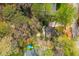 Aerial view of a wooded homesite with mature trees and a private backyard that features a swimming pool at 6795 Brandon Mill Rd, Atlanta, GA 30328