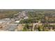 An aerial view of a business district and residential area with mature trees in the distance at 6795 Brandon Mill Rd, Atlanta, GA 30328