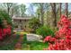 Scenic backyard view showing the exterior of the home, deck, and landscaped garden at 6795 Brandon Mill Rd, Atlanta, GA 30328