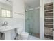 Modern bathroom with a glass shower, pedestal sink, and marble tile surround at 6795 Brandon Mill Rd, Atlanta, GA 30328