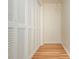 Walk-in closet boasts ample storage space with hardwood floors and custom shelving at 6795 Brandon Mill Rd, Atlanta, GA 30328