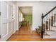 Inviting entryway with hardwood floors and staircase, leading to a sunlit room at 6795 Brandon Mill Rd, Atlanta, GA 30328