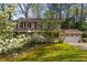 Charming two-story home with well-maintained lawn, mature trees, and blossoming dogwood trees in a beautiful yard at 6795 Brandon Mill Rd, Atlanta, GA 30328