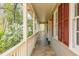 Inviting covered front porch with classic railings, shuttered windows, and exterior lighting at 6795 Brandon Mill Rd, Atlanta, GA 30328