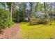 A charming two-story home on a lush green lot with mature trees and flowering bushes at 6795 Brandon Mill Rd, Atlanta, GA 30328