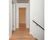 Hallway featuring hardwood floors and white walls at 6795 Brandon Mill Rd, Atlanta, GA 30328