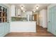 Bright kitchen featuring white cabinets, stainless steel appliances, and a breakfast bar at 6795 Brandon Mill Rd, Atlanta, GA 30328