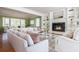Bright living room with fireplace, built-in shelving, and large windows at 6795 Brandon Mill Rd, Atlanta, GA 30328