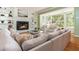 Comfortable living room featuring a fireplace with built-in bookshelves and large windows at 6795 Brandon Mill Rd, Atlanta, GA 30328