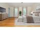 A lovely main bedroom features hardwood floors, neutral walls, and bright natural light at 6795 Brandon Mill Rd, Atlanta, GA 30328
