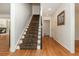 Elegant staircase with hardwood floors, a patterned runner, and white trim at 6795 Brandon Mill Rd, Atlanta, GA 30328