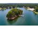 Scenic view of a lakeside island with a private dock surrounded by calm water at 9176 Lakeview Parkway, Villa Rica, GA 30180
