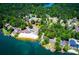 Aerial view of the lakefront community, showcasing the private beach, boat slips and dense tree cover at 9176 Lakeview Parkway, Villa Rica, GA 30180