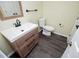 Bright bathroom features a modern vanity, a mirror, modern fixtures, and dark floors at 9176 Lakeview Parkway, Villa Rica, GA 30180