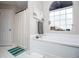 Bathroom featuring a large soaking tub and patterned window at 9176 Lakeview Parkway, Villa Rica, GA 30180