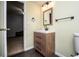 Bathroom features a modern vanity with a framed mirror, modern fixtures, and dark floors at 9176 Lakeview Parkway, Villa Rica, GA 30180